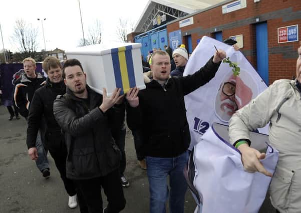 Fans carry a coffin during a protest before the Bolton Wanderers match at Elland Road