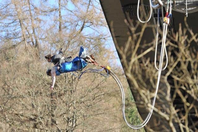 Newly wed couple Natalie and Dave Hitchen took a leap of faith moments after tying the knot with a bungee jump over the River Garry in Perthshire. See Centre Press story CPBUNGEE; A daredevil couple threw themselves straight into marriage - making a 140-foot bungee jump seconds after they tied the knot. Natalie Hough and Dave Hitchen, both 27 from Cheshire said 'I do' to humanist minister, Jane Hechtel, standing at the Highland  the River Garry in Perthshire. Then, wrapped in each other's arms, they leapt off the Highland Fling bungee jump platform at Killiecrankie in full wedding attire. Having gathered everyone the night before for a ceilidh in Blair Atholl, only the two best men knew the couple's plan to jump the next day.
