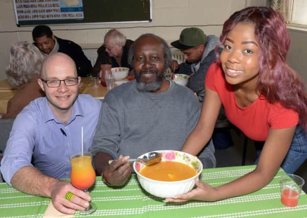 Turtle Bay's Robert Tiffin and Gail Bear serve Carl Hylton at  the West Indian Centre in Chapeltown. Pic: Gary Longbottom.