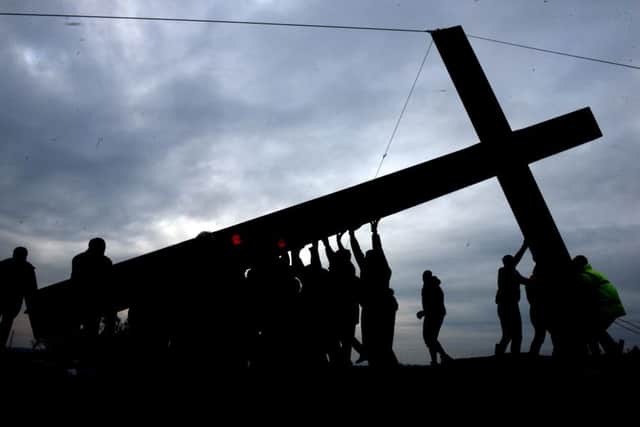 Volunteers  erecting the cross on Otley Chevin  on Saturday.