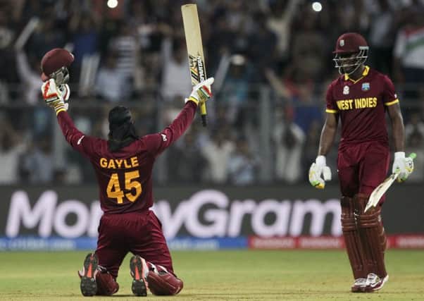 BIG HITTER: West Indies Chris Gayle raises his bat after scoring hundred runs against England Picture: AP/Rafiq Maqbool.