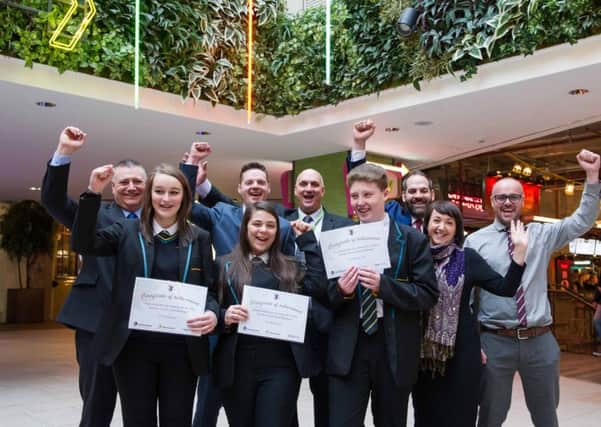 Pupils from Leeds West Academy punch the air after winning the Trinity Kitchen Challenge.