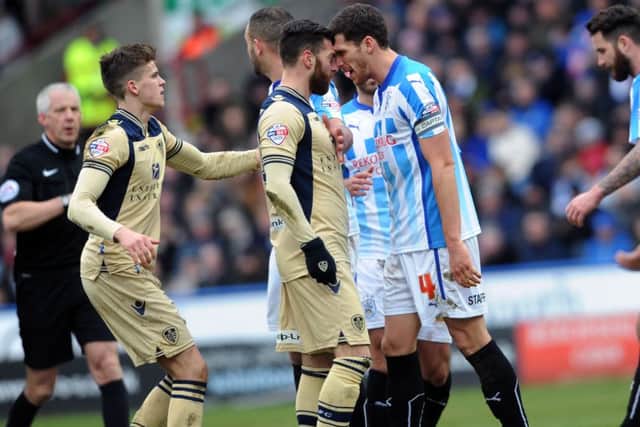 Leeds United's Mirco Antenucci and Huddersfield's Mark Hudson clash during last January's encounter at John Smith's Stadium.  Picture: Jonathan Gawthorpe.