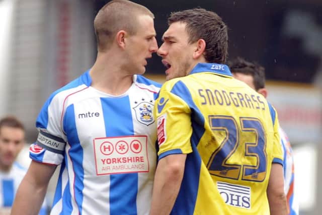 Peter Clarke and Robert Snodgrass go head to head during a meeting begtween the two in 2010.