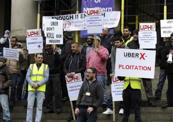 Taxi drivers protest at Leeds Town Hall over minimum fare cuts  which are being imposed by Uber. Pictures: Bruce Rollinson