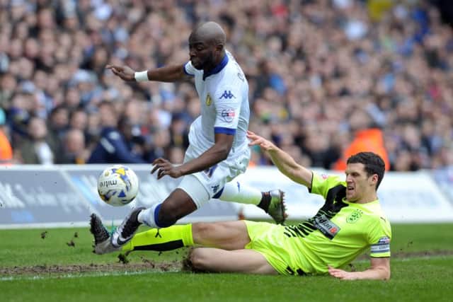 Souleymane Doukara is tackled by Mark Hudson.  PIC: Tony Johnson