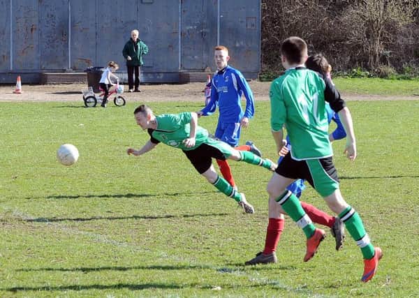 Michael Chadwick scores the opening goal for Chickenley against Hartshead in the Brook Butler Cup.