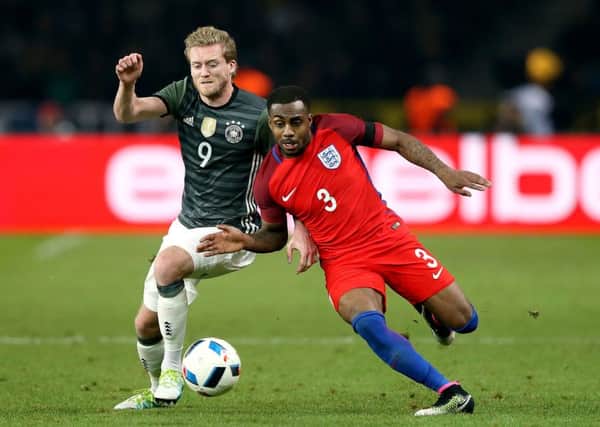 England's Danny Rose and Germany's Andre Schurrle battle for the ball.