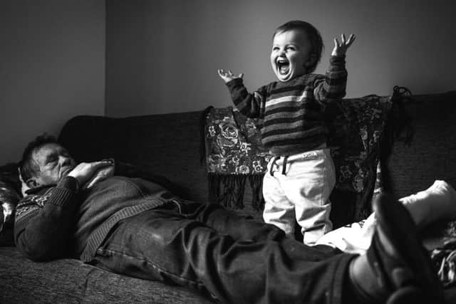 A grandson and his grandfather, taken by Alex Ingle, was the winning photograph in the Open Competition, Smile category.