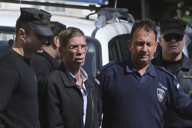 EgyptAir plane hijacking suspect Seif Eddin Mustafa, second left, is escorted by Cyprus police officers as he leaves court