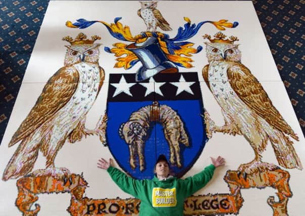 The giant Lego Leeds City Crest, made from 201,748 bricks taking over 180 hours to build. Pictured, Harriet Chapman the daughter of the Lord Mayor of Leeds Councillor Judith Chapman. Pictures: James Hardisty.