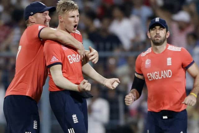England's Joe Root is congratulated after taking the wicket of West Indies' Johnson Charles Picture: (AP/Saurabh Das)