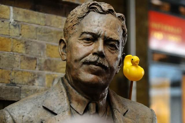 DUCK: A protester adds a duck to the statue.