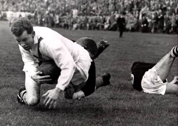 Winger Mick Sullivan defies the attentions of Graham Kennedy to score in the second Test against New Zealand at Bradford in 1961