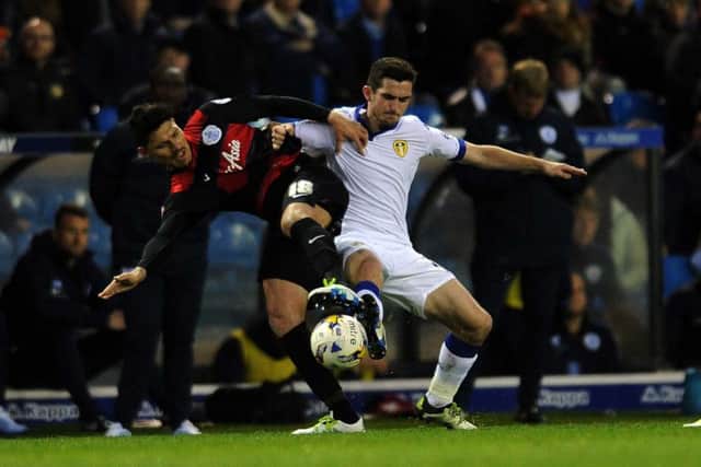 Leeds United's Lewis Cook battles with QPR's Alejandro Faurlin.
 PIC: Jonathan Gawthorpe