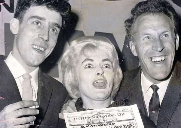 Viv Nicholson and husband Keith collect their Littlewoods pools cheque from Bruce Forsyth.