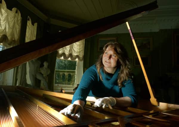 Stephanie  Davies, assistant  community curator at Lotherton Hall  checking on one of a pair of  Erard pianos.