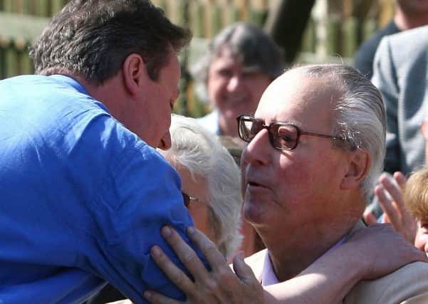 David Cameron greets his late father Ian at a campaign rally in 2010. Johnny Green/PA.