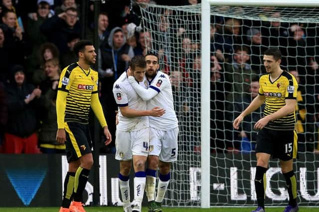 Some Leeds United fans feel Scott Wootton, here being consoled by Giuseppe Bellusci after scoring an own goal at Watford, should, perhaps, replace the Italian centre-back for Saturday's trip to table-topping Burnley.