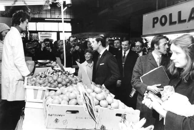 Leeds, 15th December 1975 - 
Prince Charles, The Prince of Wales, chats to a greengrocer in Kirkgate Market during his walkabout.