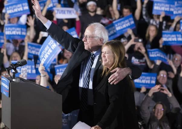 Democratic presidential candidate Sen. Bernie Sanders, I-Vt., center left, waves to the crowd with his wife Jane after speaking during a primary night watch party at Concord High School, Tuesday, Feb. 9, 2016, in Concord, N.H. (AP Photo/John Minchillo)