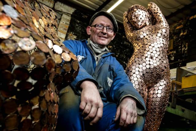 Shaun Gagg with an example of his work forged from 2p pieces at his workshop in Filey. Picture: Ross Parry Agency