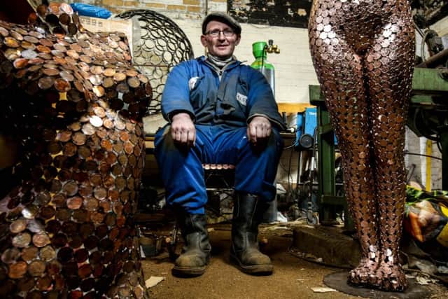 Shaun Gagg with an example of his work forged from 2p pieces at his workshop in Filey. Picture: Ross Parry Agency