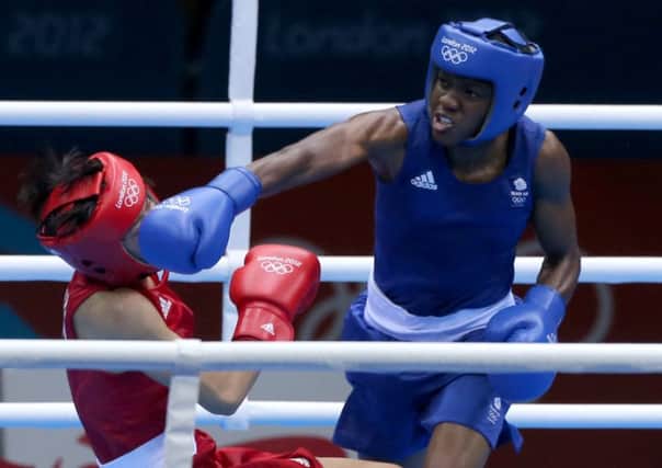 Great Britain's Nicola Adams knocks down China's Canacan Ren during the Women's fly 55kg final at London 2012