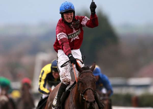 David Mullins celebrates on Rule The World after winning the Crabbie's Grand National.