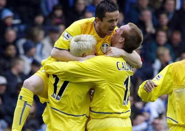Steven Caldwell, right, celebrates his goal with team-mates Alan Smith and Gary Kelly.