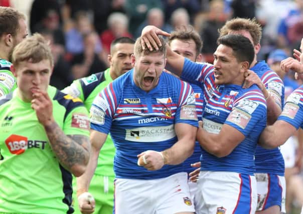 Nick Scruton celebrates scoring Wakefield's first try against Wigan. PIC: Andy May