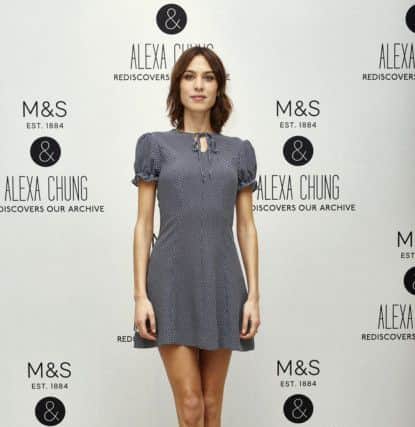 Alexa Chung wearing the Elsie dress, Â£39.50, at Marks and Spencer Marble Arch store - later she took to the tills to serve customers.
