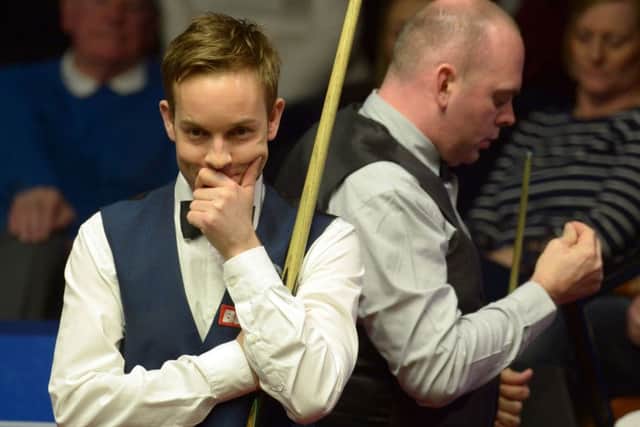 Ali Carter (left) and Stuart Bingham during day one of the Betfred Snooker World Championship.