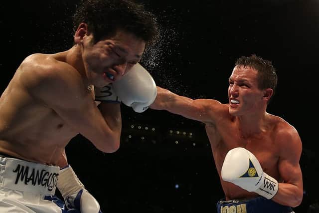 Josh Warrington (right) and Hisashi Amagasa slug it out at the First Direct Arena in Leeds. Picture: Simon Cooper/PA