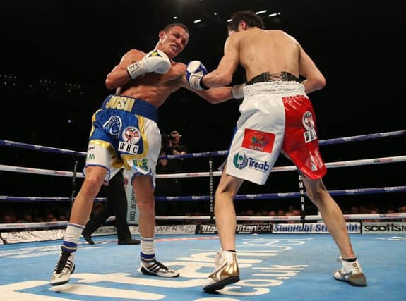Josh Warrington (left) and Hisashi Amagasa battle at Leeds's First Direct Arena. Picture: Simon Cooper/PA.