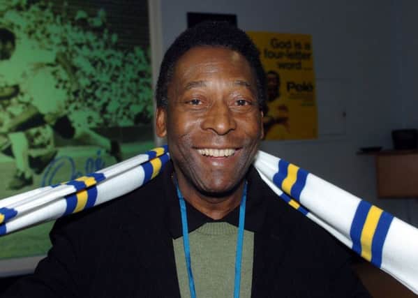 Pele dons a Leeds United scarfe during his visit to  ASDA House Leeds in 2006.