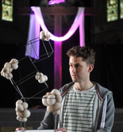 Student pastor Chris Balding looks at work by students from Leeds College of Arts' Christian Union. Picture Tony Johnson