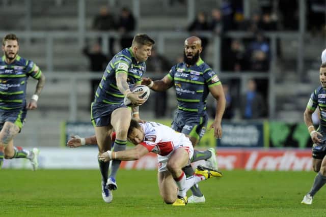Liam Sutcliffe looks for support as Kyle Amor holds his run at Langtree Park.  Picture: Bruce Rollinson