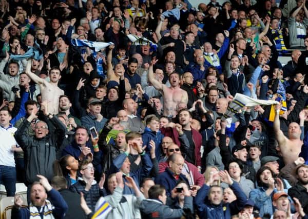 MAYHEM: Leeds United's travelling supporters celebrate a late equaliser for Stuart Dallas at Hull City. Picture by Simon Hulme.