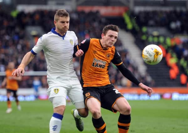 Gaetano Berardi is challenged by Andy Robertson.