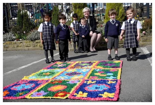 Pupils say it with flowers in Belgian style to welcome Leeds school's new headteacher Sue Woodroofe.