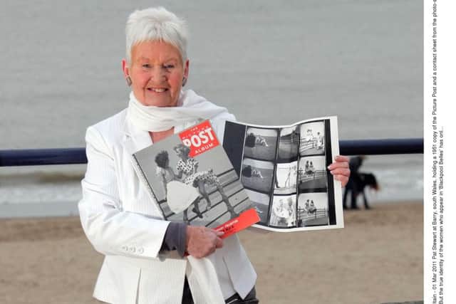 Pat Stewart  holding a 1951 copy of the Picture Post and a contact sheet from the photo-shoot in Blackpool with Bert Hardy. (Photo by REX/Shutterstock).