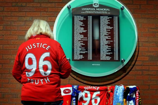 Fans arrive at the Hillsborough Memorial, at Anfield, Liverpool, after the verdicts were delivered. Picture by Simon Hulme