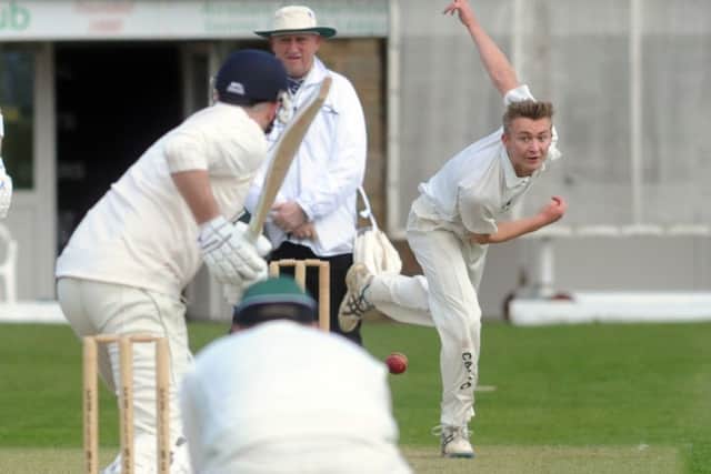Collingham bowler Chris Bridge in Aire Wharfe action at home to Otley.