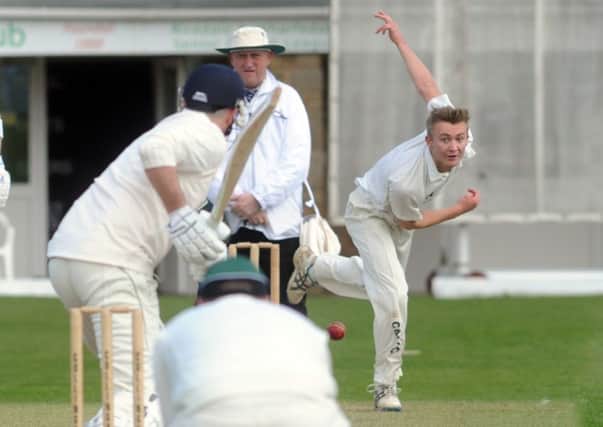 Collingham bowler Chris Bridge in Aire Wharfe action at home to Otley.