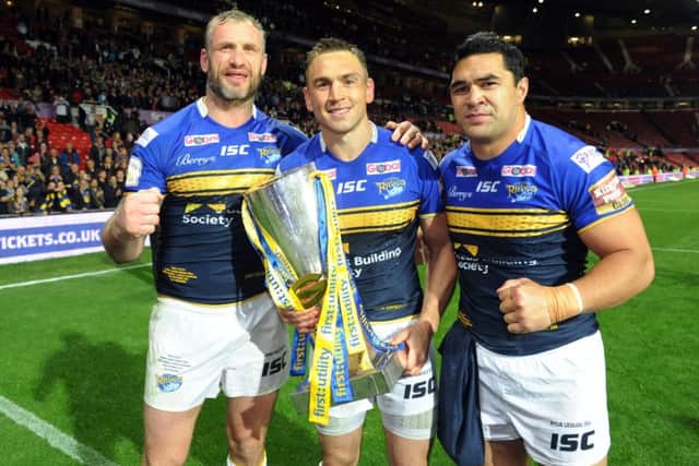 LEGEND: Kevin Sinfield, centre, with Leeds Rhinos' team-mates Jamie peacock, left and Kylie Leuluai after completing the treble at Old Trafford last year. Picture: Steve Riding.
