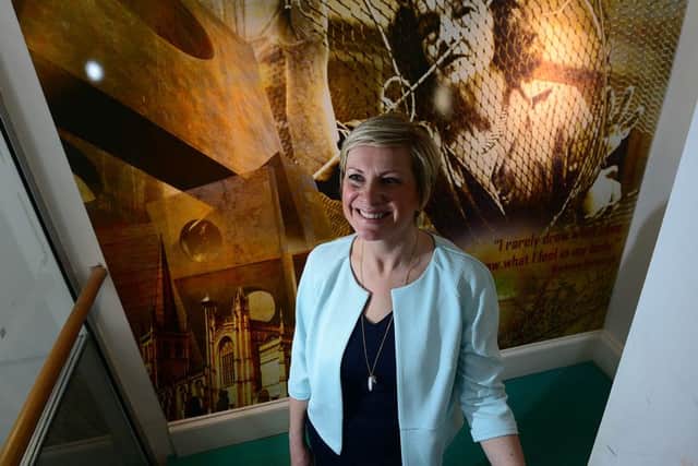 Headteacher of Wakefield Girls High School, Nina Gunson with a portrait of Barbara Hepworth in the school's Hepworth art block. Picture Scott Merrylees