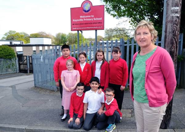 Headteacher Maria Townsend pictured with year six pupils at Raynville Primary School in Bramley. PIC: Jonathan Gawthorpe