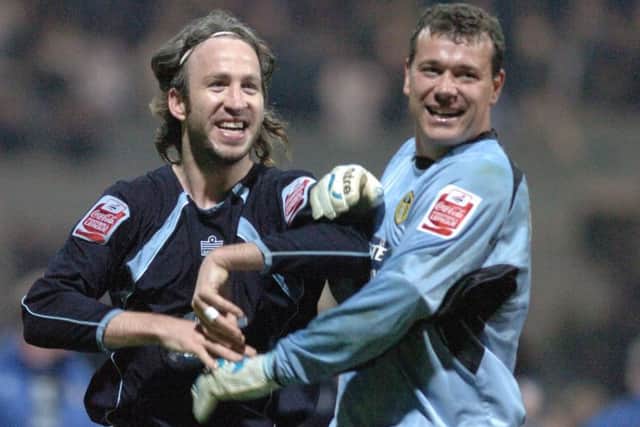 Shaun Derry and Neil Sullivan celebrate after final whistle at Preston.