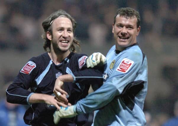 Shaun Derry and Neil Sullivan celebrate after final whistle at Preston.